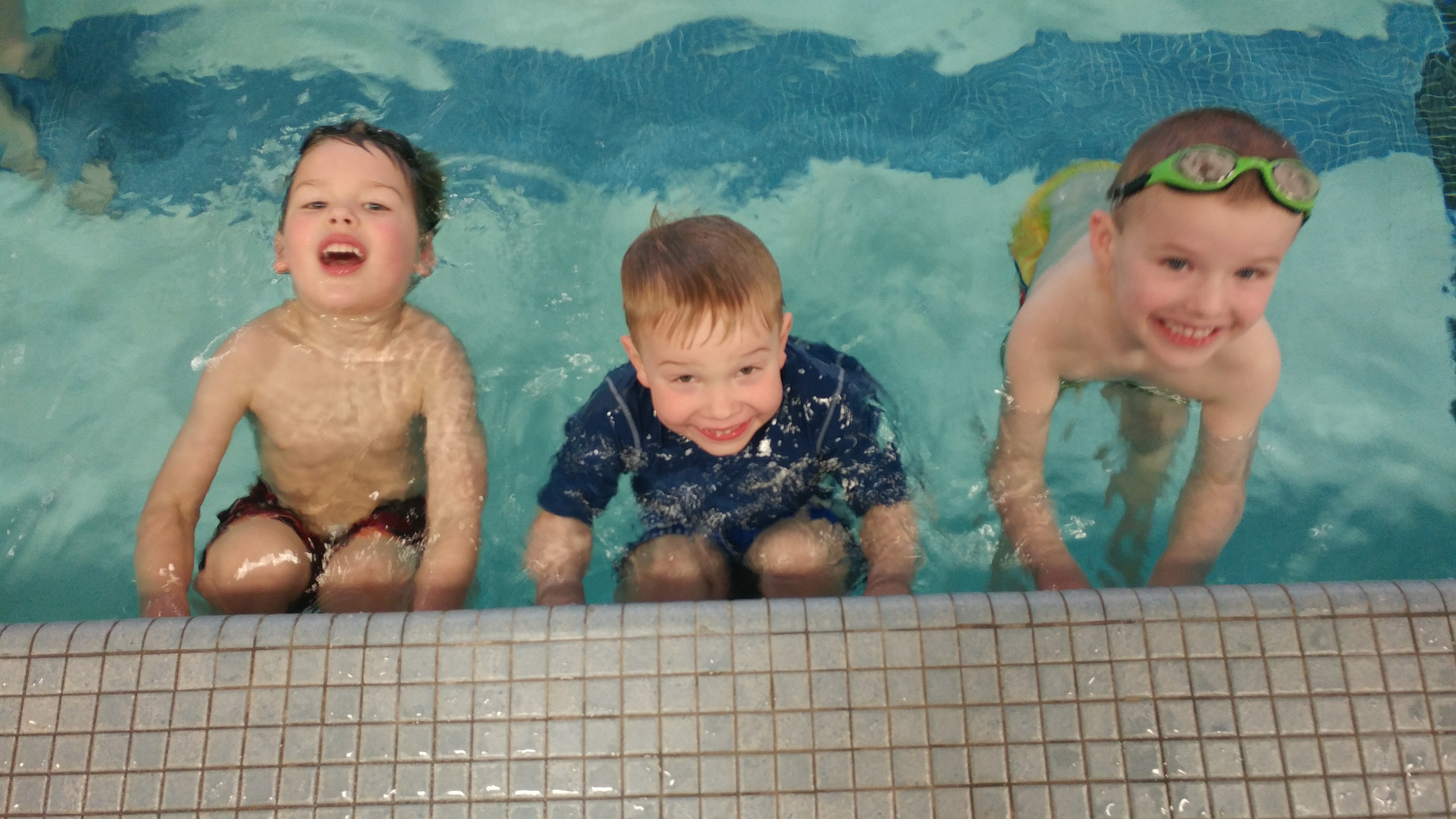 Kids in pool taking swim lessons