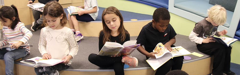 Kids sitting and reading.