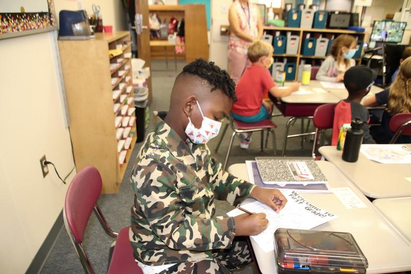 Photo of boy coloring.
