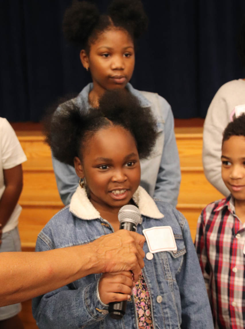 Girl talking into microphone.