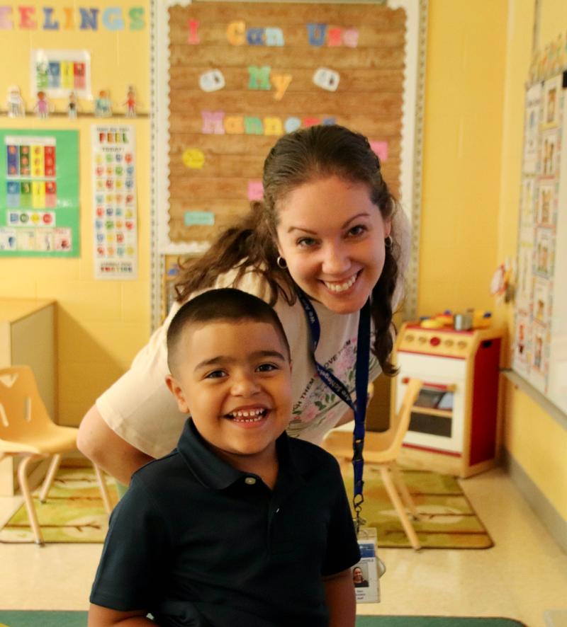 Student and teacher smiling.