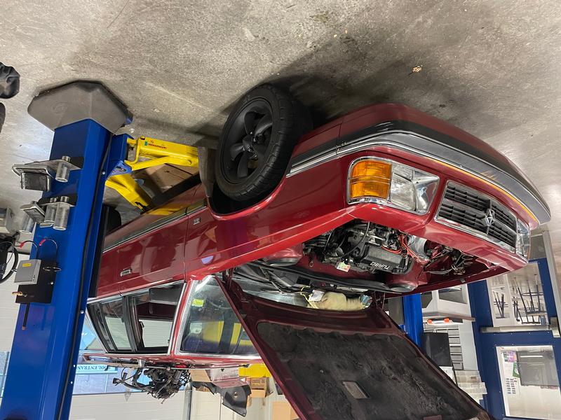 The red wagon with the hood up and a new engine inside.