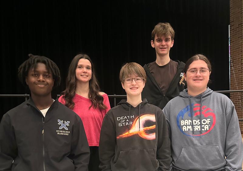 Five teens standing together.