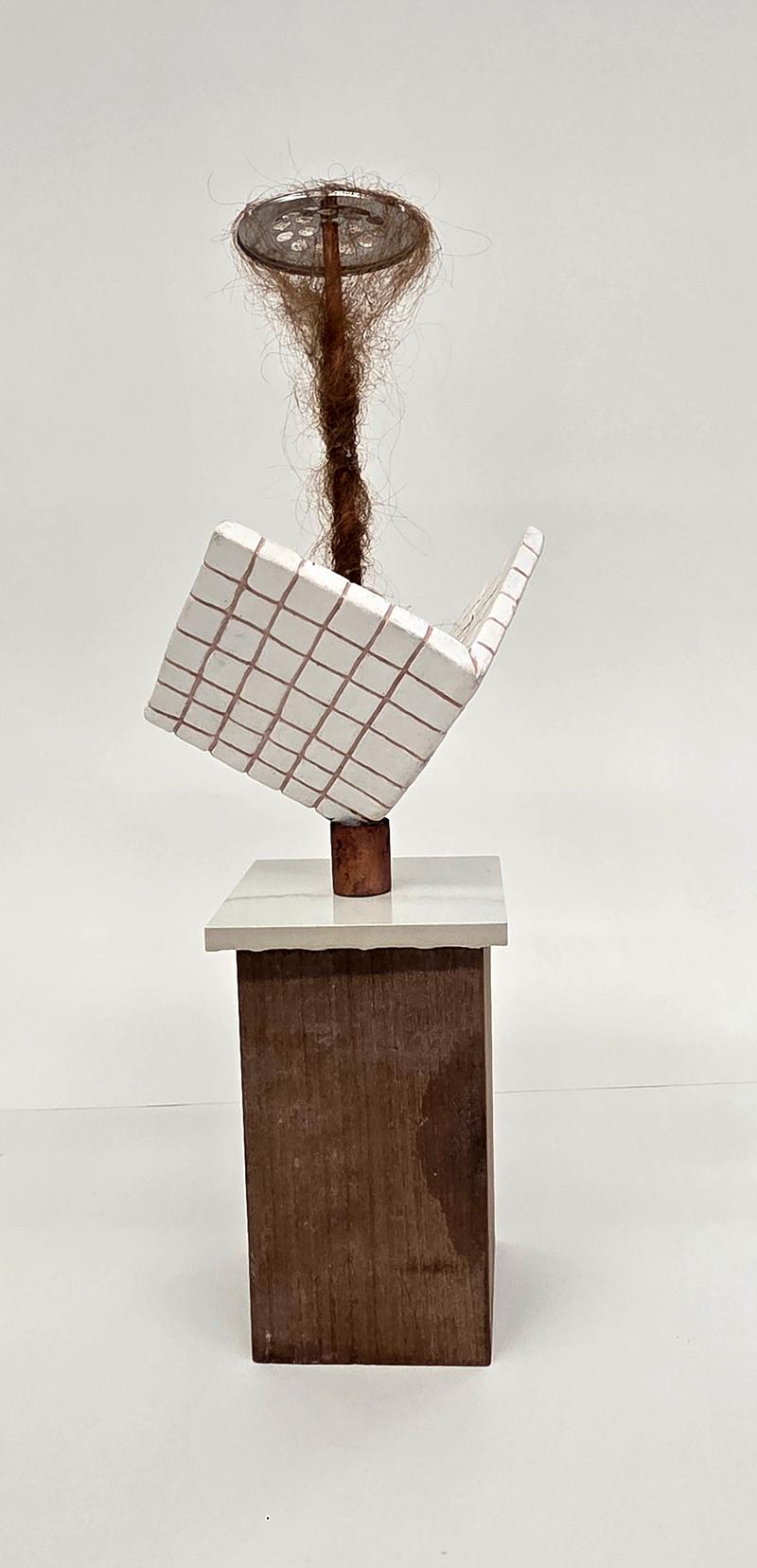 Sculpture of shower tiles below a drain with a long mass of hair hanging from it.