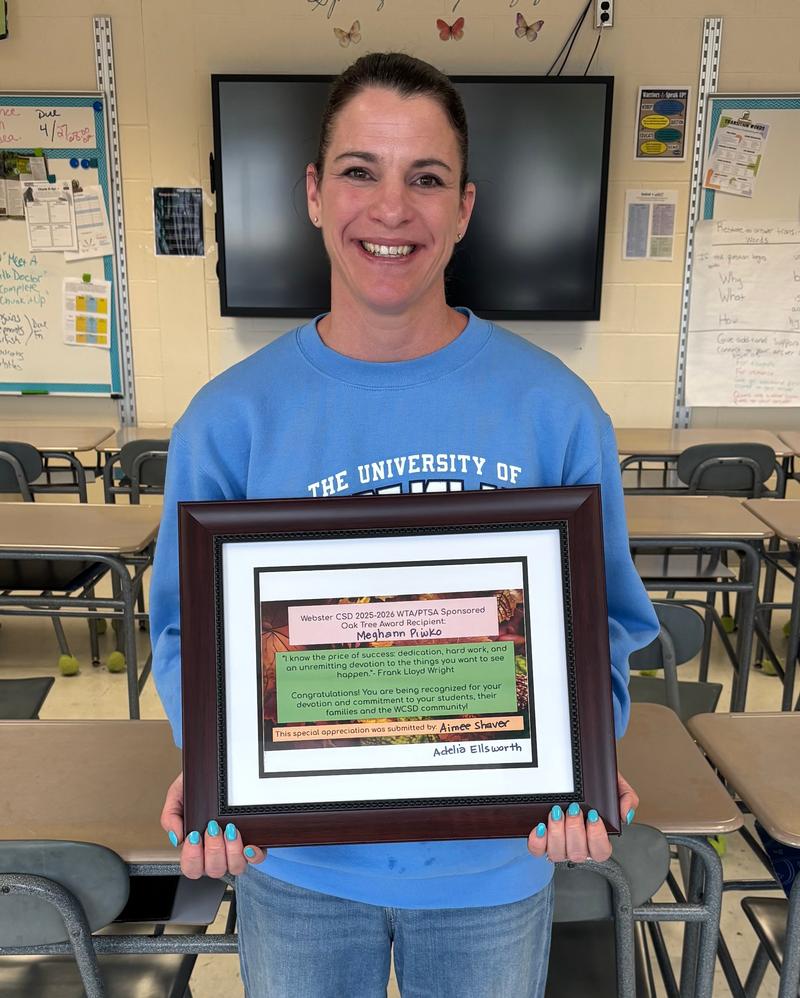 Woman holding plaque.