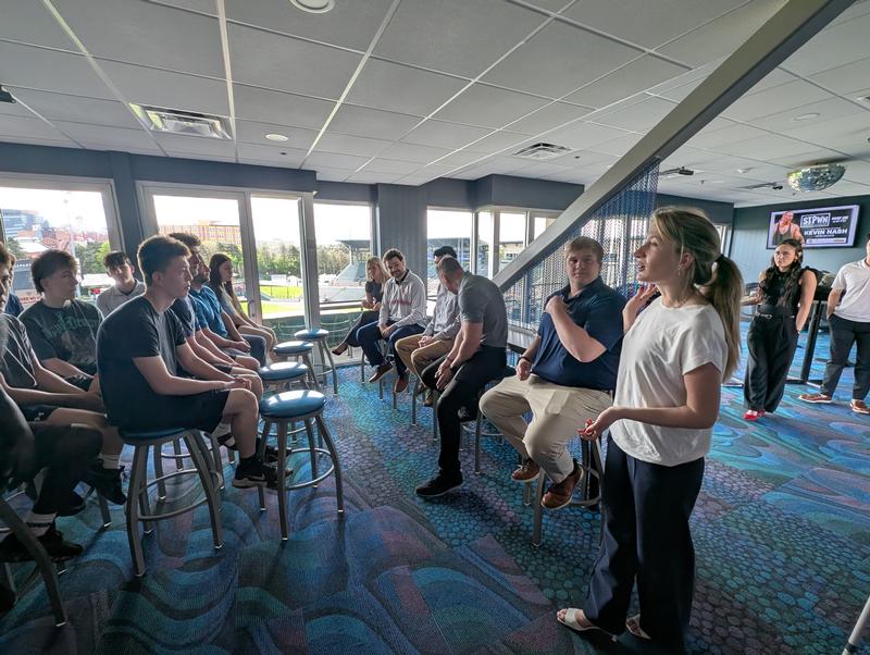Teens listing to five adults talk to them.
