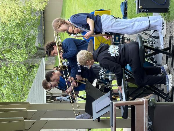 Five teens playing struments