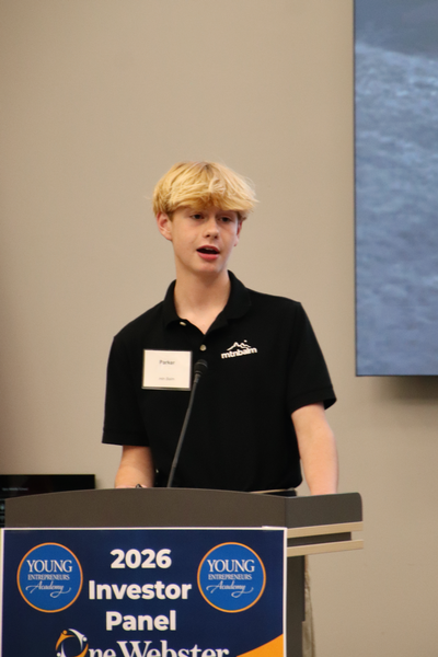 Teen standing at a podium.