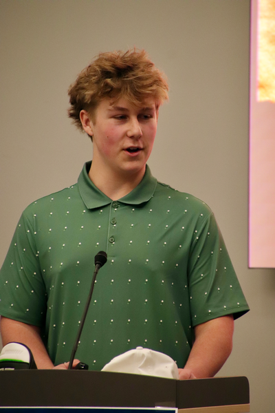 Teen talking into mic. 