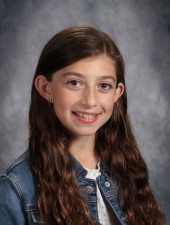 Girl in white shirt and jean jacket smiling
