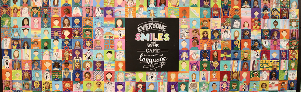 Bulletin board that reads, "Everyone smiles in the same language."