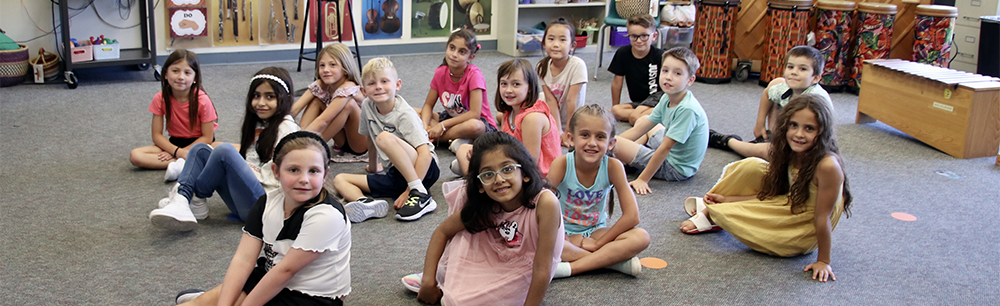 Groups of children sitting on the floor.