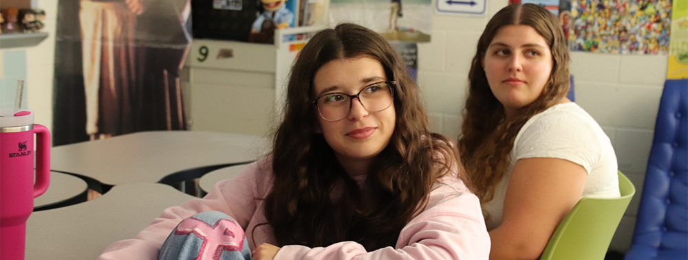 Two teenage girls looking off camera.