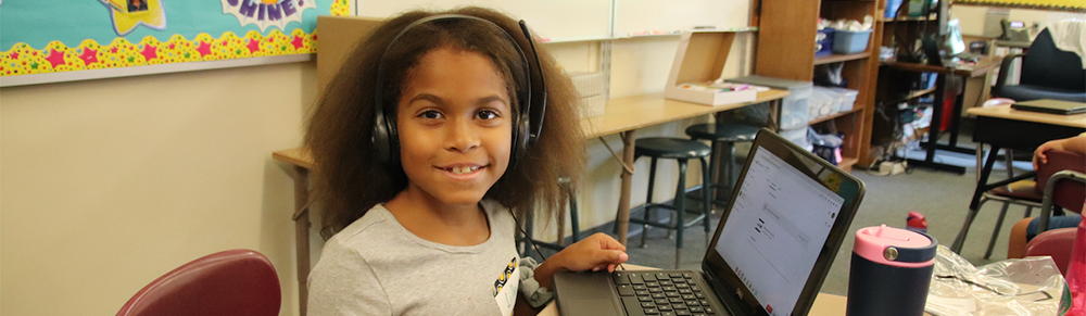 Photo of a girl using a laptop. 